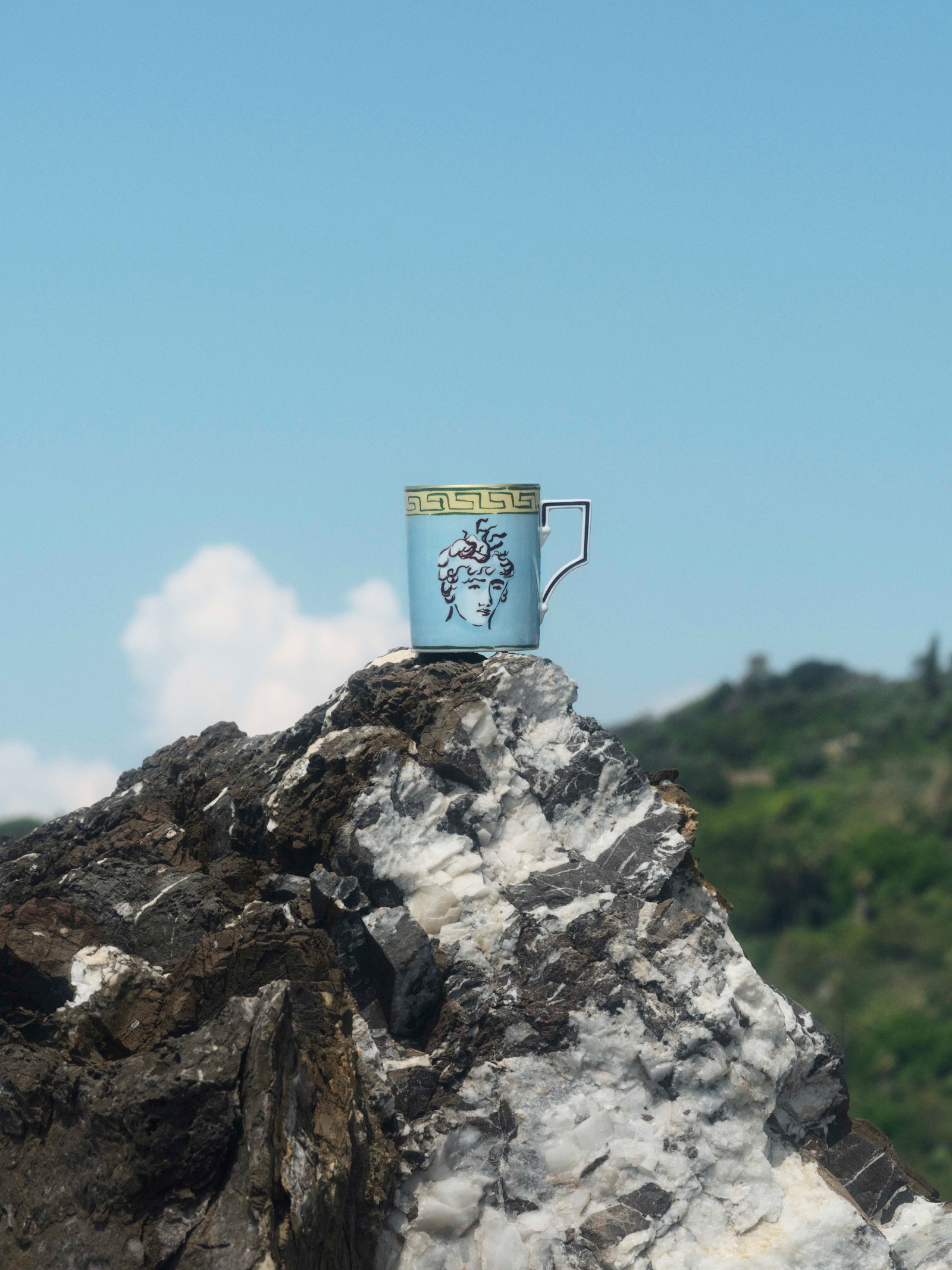 Images may contain rock cliffs nature outdoor cup mountain range peak sky and landscape